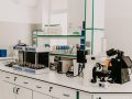 A clean laboratory workspace with scientific equipment including a microscope and laboratory instruments