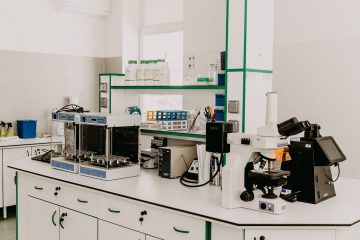 A clean laboratory workspace with scientific equipment including a microscope and laboratory instruments